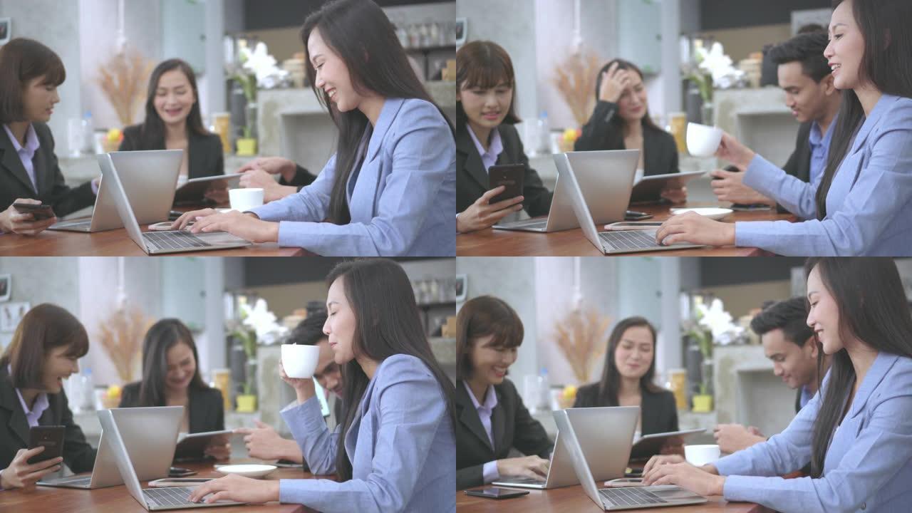 美丽的女人在开会时坐在咖啡馆里的笔记本电脑上工作。