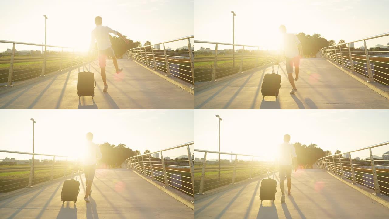 镜头耀斑: 兴奋的人在日落时分走向机场时点击了脚跟。