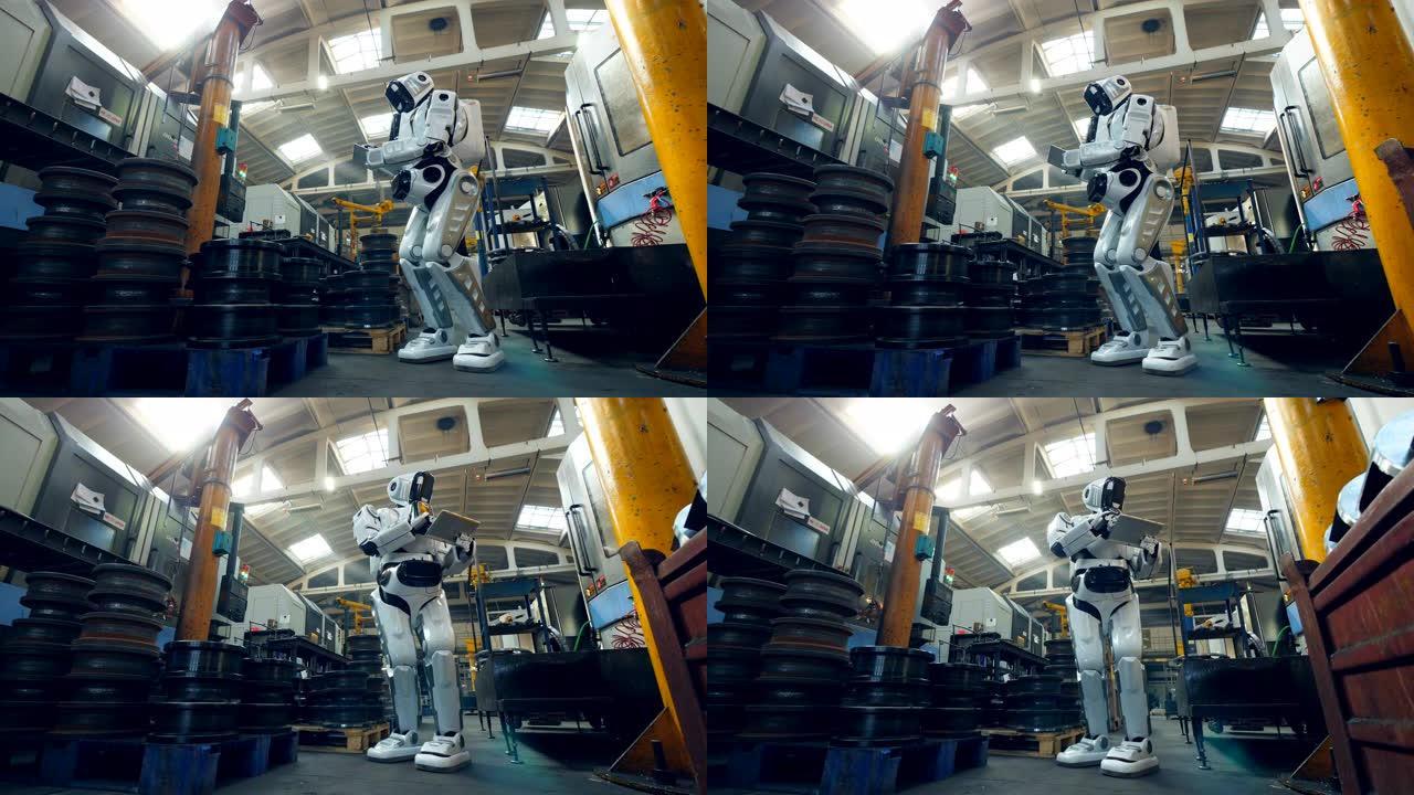 机器人在工厂用平板电脑检查金属片。