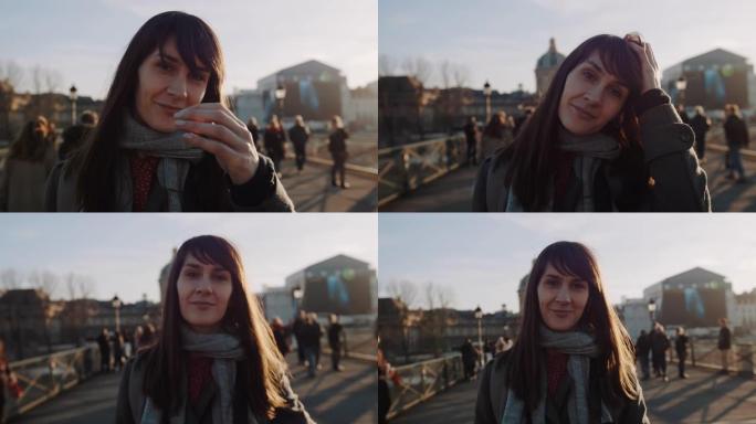 幸福美丽微笑的年轻女子的生活方式肖像在日落秋巴黎广场慢动作为相机摆姿势。