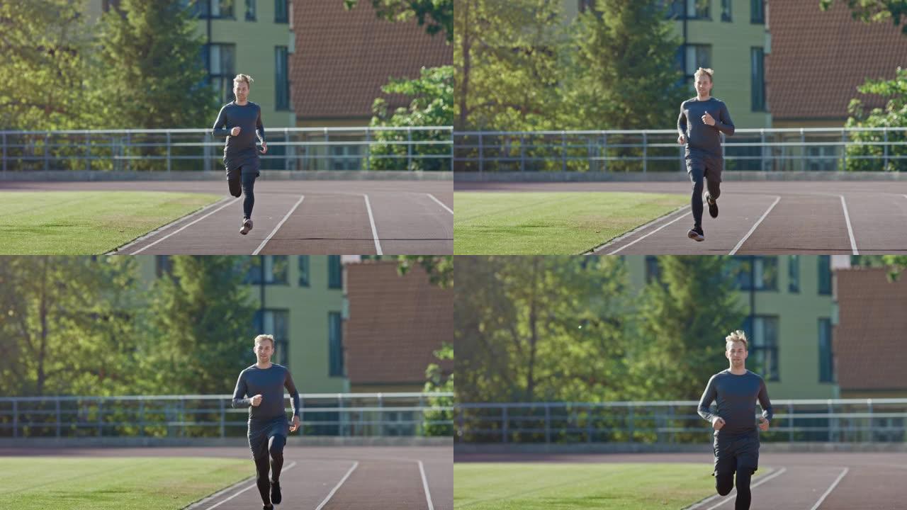 穿着灰色衬衫和短裤的微笑运动健美男子在体育场慢跑。在一个温暖的夏日下午，他跑得很快。运动员做他的常规