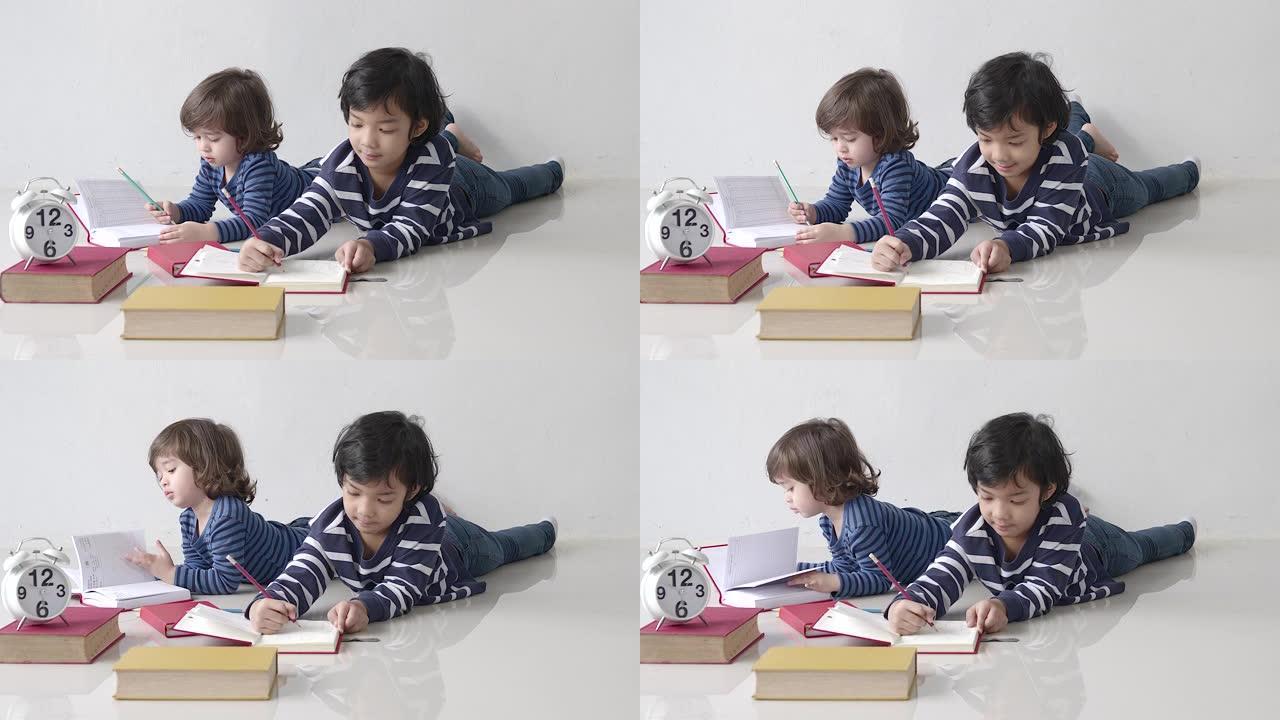 小男孩在家学习写字，在笔记本上写东西，享受学习，教育理念
