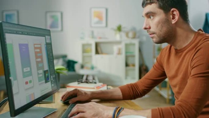 英俊的软件工程师工作在UX/UI移动应用程序模板，使用个人计算机。自由程序员在舒适的客厅工作。