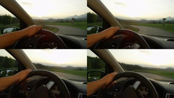 慢动作: 无法识别的人在日落时驾驶时握住方向盘