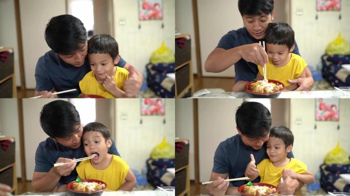 快乐的父子，小男孩喜欢吃katsudon，日本炒肉加米饭在家，2岁