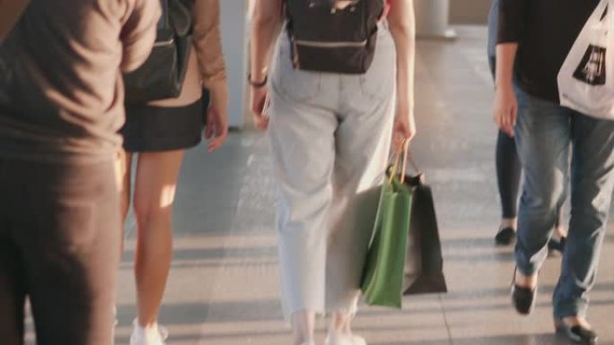 火车站月台上两女游客提着购物袋散步慢动作