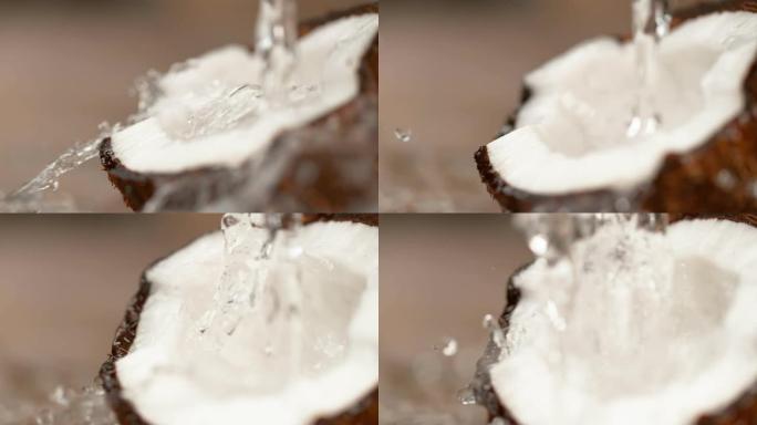 慢动作，DOF: 清新的水流过美味的成熟椰子一半。