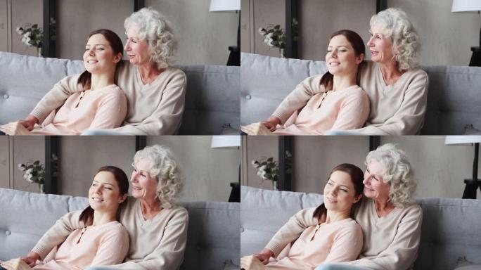 快乐宁静的祖母和成年的孙女在家里建立联系