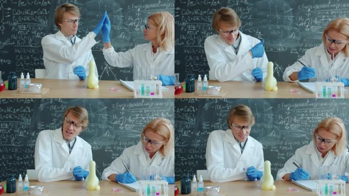 快乐的男人和女人在实验室进行化学测试时会击掌并竖起大拇指
