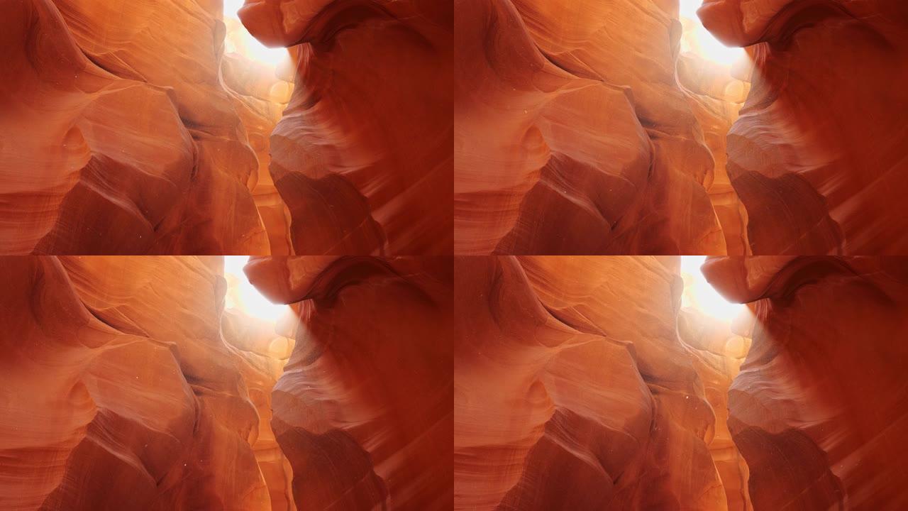 羚羊峡谷的尘埃在阳光下飞翔。缩小美国亚利桑那州羚羊峡谷红墙的镜头