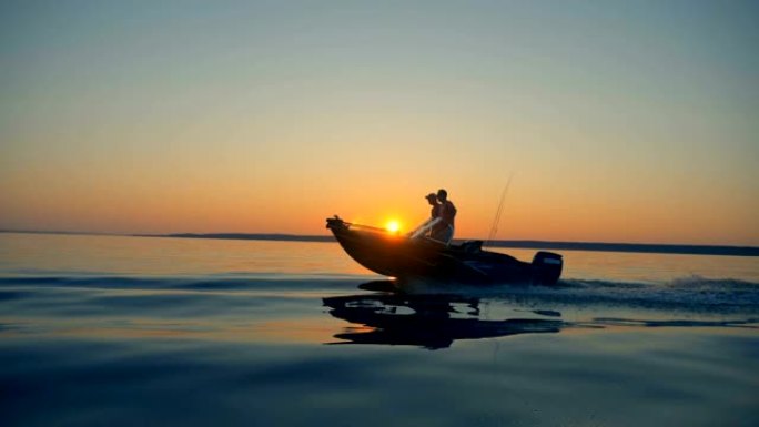 一艘钓鱼快艇与两名男子在湖上移动的侧视图