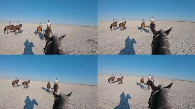 一群骑马者的慢动作视图在Makgadikgadi盐锅的广阔空间中慢跑