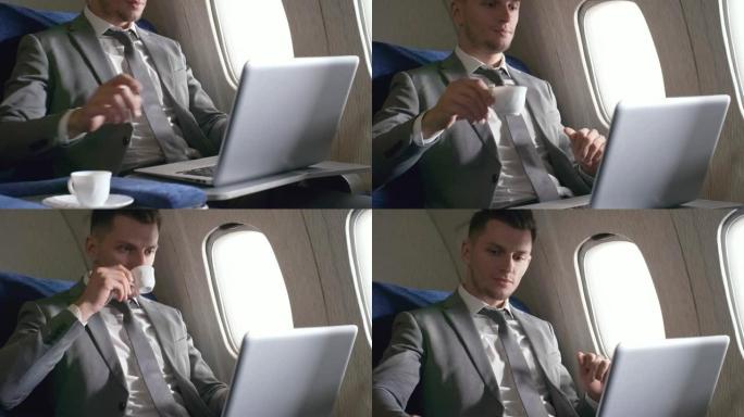 忙碌的商人在飞机上在笔记本电脑上工作