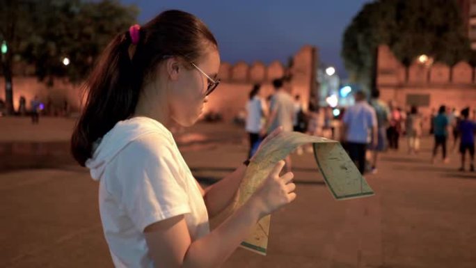 十几岁的女孩拿着旅游地图检查