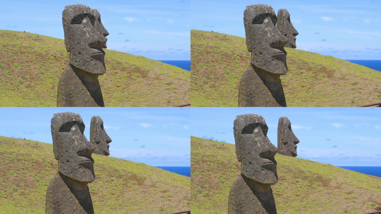 无人机: 在俯瞰海洋的草山上拍摄的moai雕塑令人叹为观止