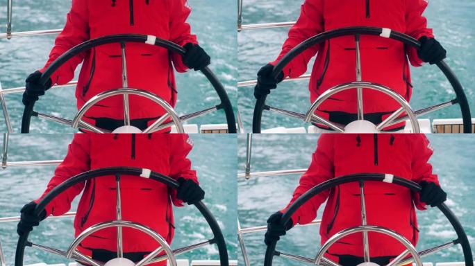 一个穿着红色派克大衣的人拿着船的轮子