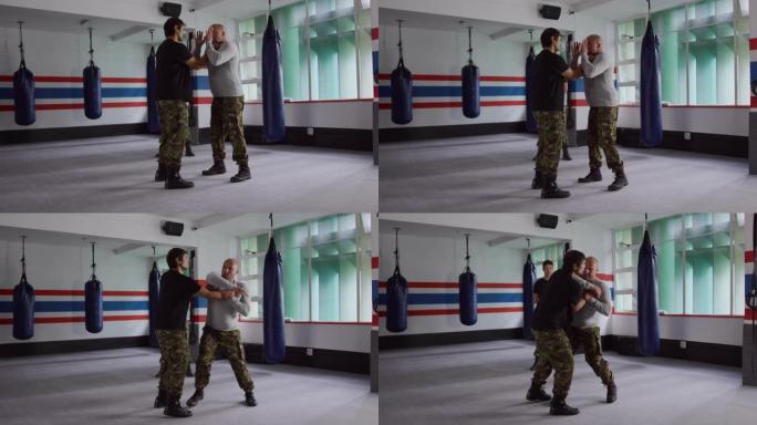 高加索人从健身房的教练那里学习武术