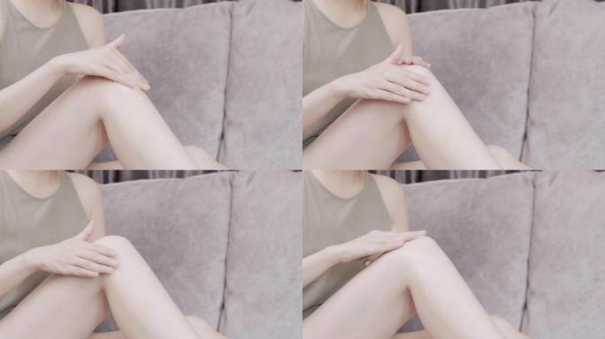 女人在腿上涂抹保湿霜。身体护理概念