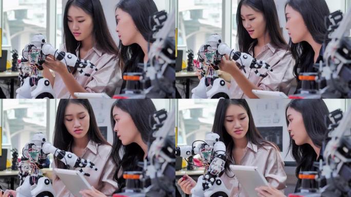 两个十几岁的女孩在学校机器人俱乐部项目的一个功能齐全的可编程机器人上工作。创意设计师在车间测试机器人