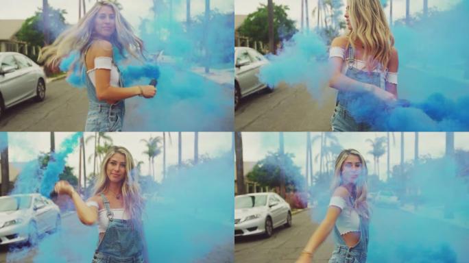 年轻的时髦女孩在城市街道上与烟雾弹一起在外面跳舞