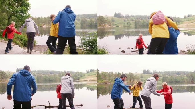 年轻的家庭走到湖边，在岸边玩耍，英国湖区