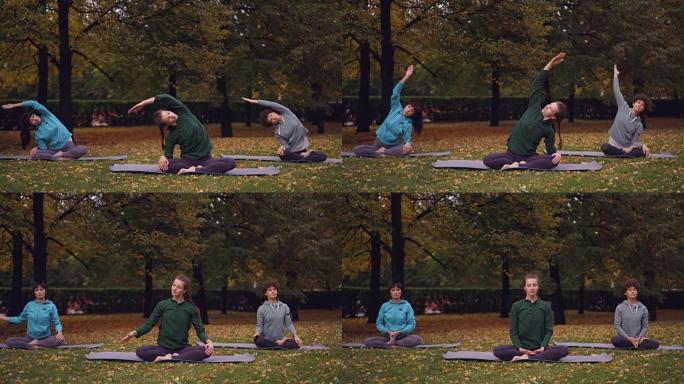 在公园的露天练习中，女瑜伽教练正在展示伸展运动，然后在荷花姿势放松，闭着眼睛坐在垫子上。
