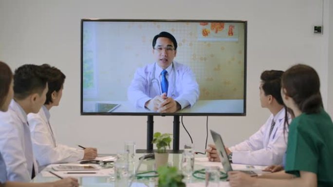 医疗团队在医院会议室举行在线视频会议。