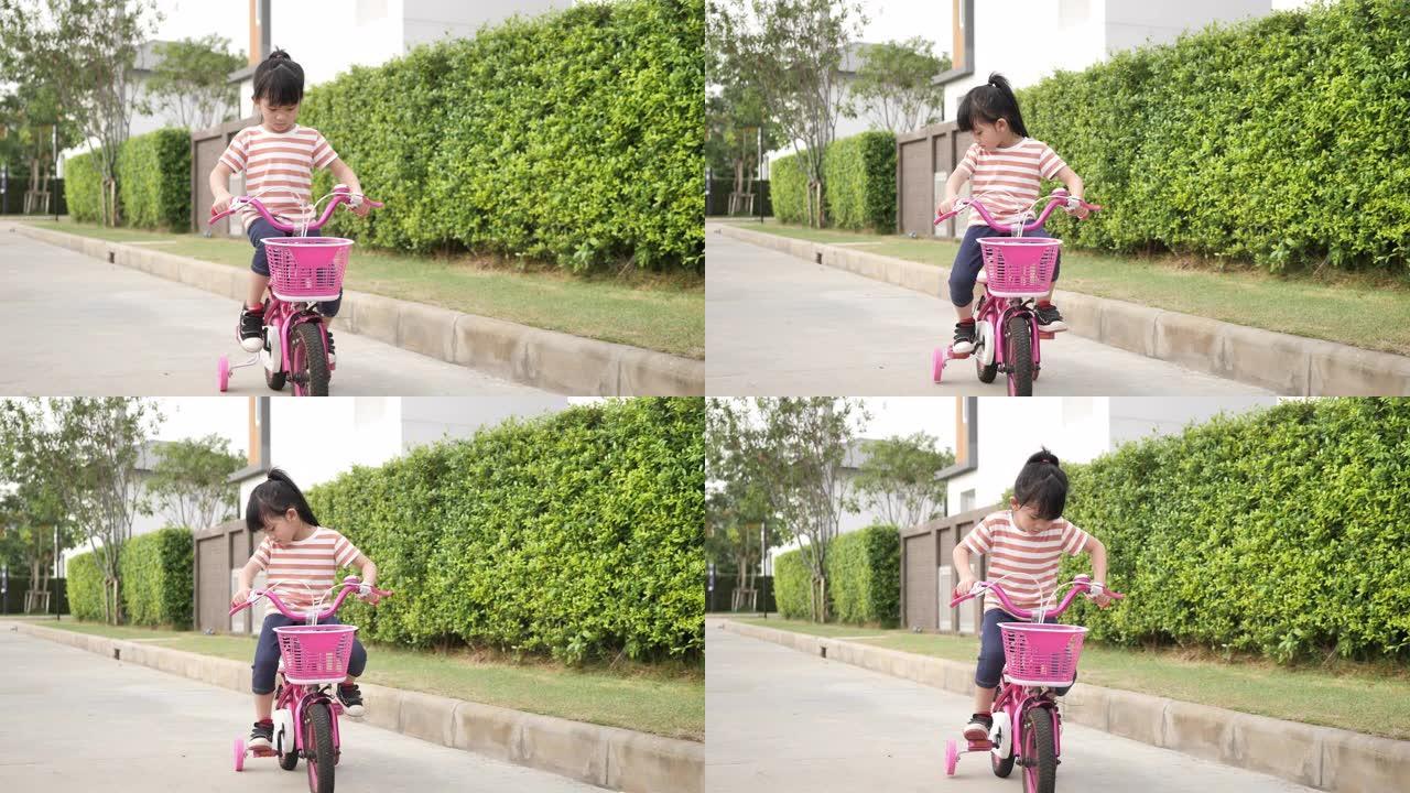 亚洲女孩在路上骑自行车