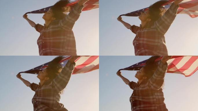 女人在阳光下的海滩上挥舞着美国国旗4k