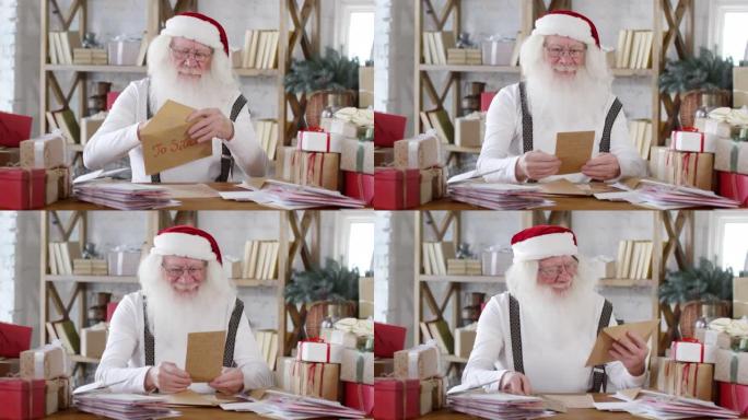 开朗的圣诞老人读信和笑