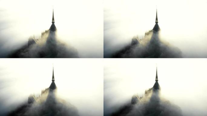 在诺曼底史诗般的日出期间，空中拍摄，雾云流过著名的雄伟的圣米歇尔要塞城堡。