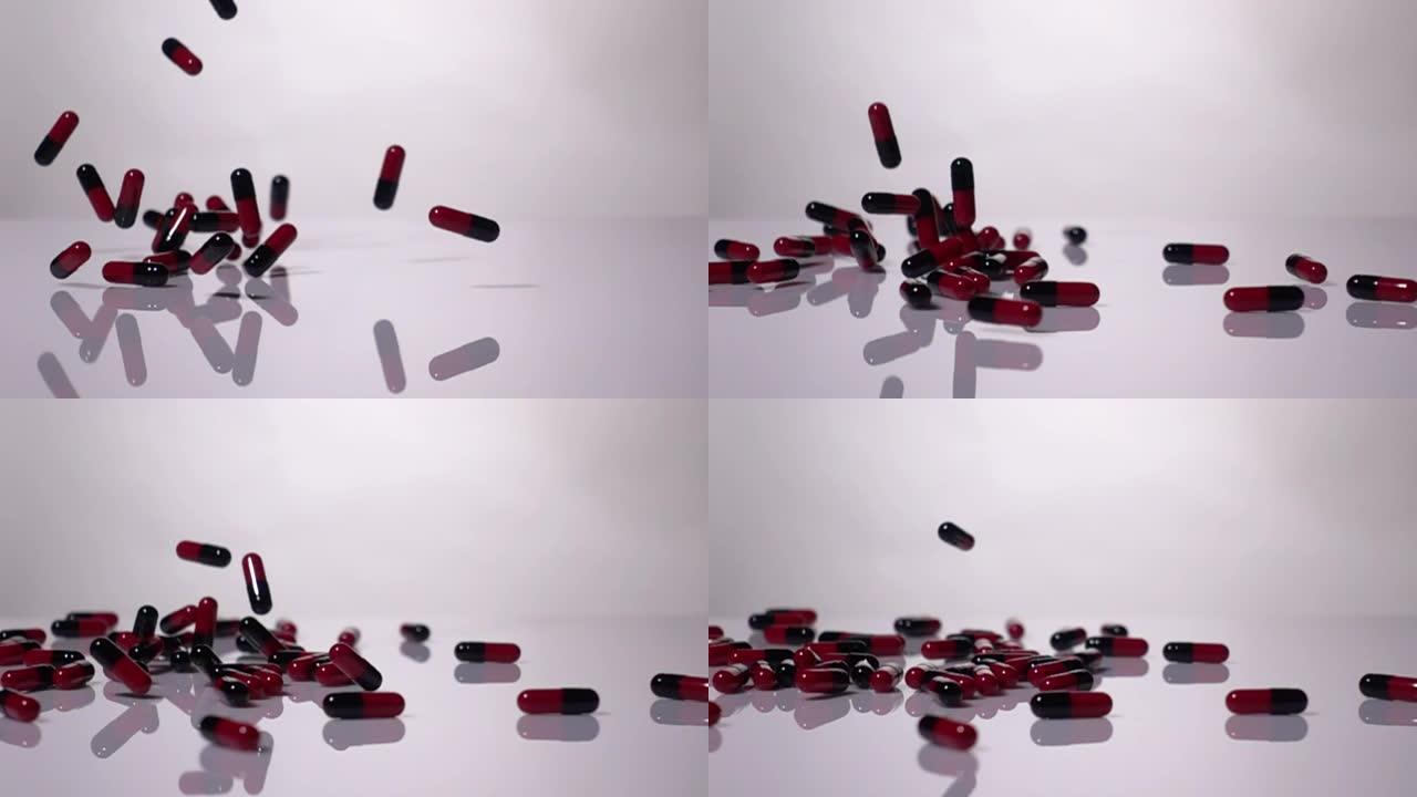 超级慢动作: 白色背景上的红色和黑色胶囊掉落