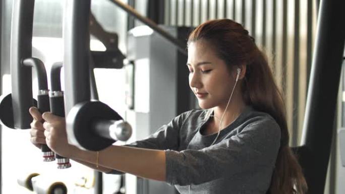 亚洲女性锻炼使她的手臂更强壮，锻炼机器