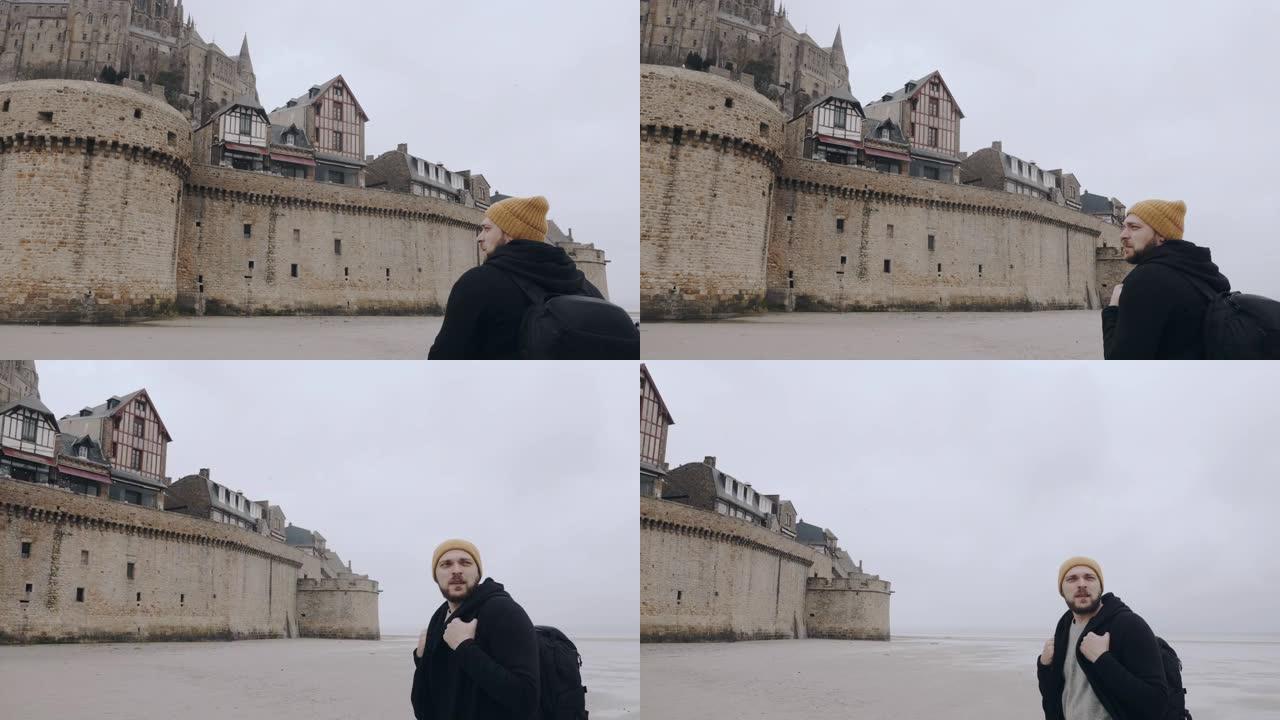 摄像机在快乐兴奋的游客周围移动，背包被史诗般的圣米歇尔山城堡堡慢动作惊呆了。
