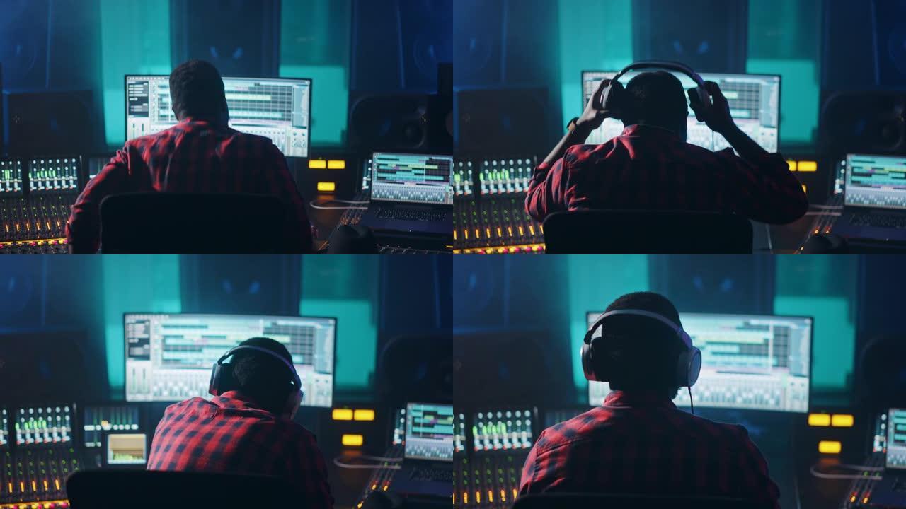 时尚的艺术家，音乐家，音频工程师，制作人在音乐录音室的控制台上进行，使用计算机屏幕显示DAW软件的用