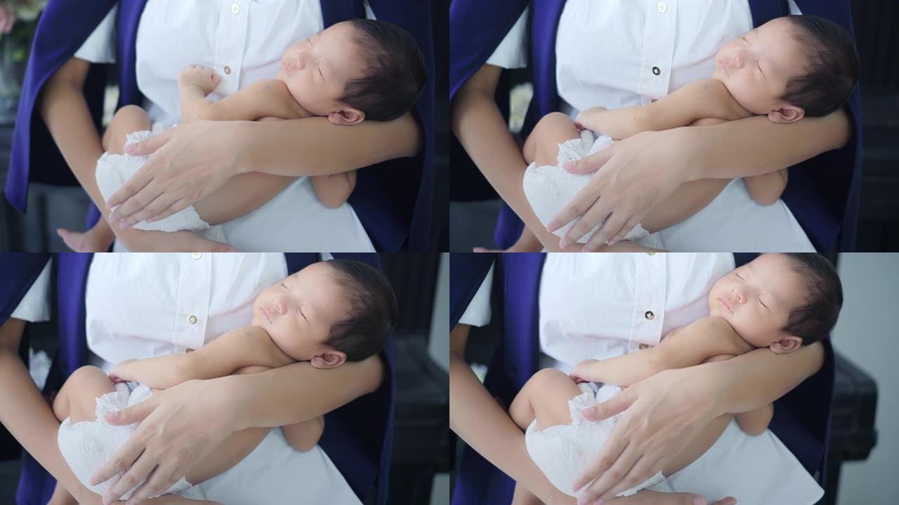 商业母亲抱着熟睡的男婴