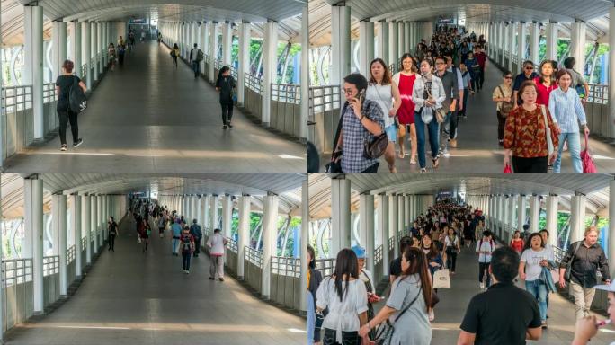 曼谷BTS Chong Nonsi高峰时段，拥挤的匿名人士在高架地铁系统站的立交桥上行走，交通和乘客