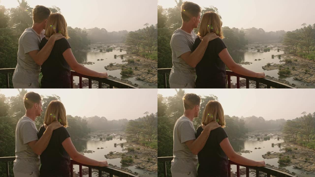 夫妇在阳台上看着斯里兰卡阳光明媚、宁静的河景