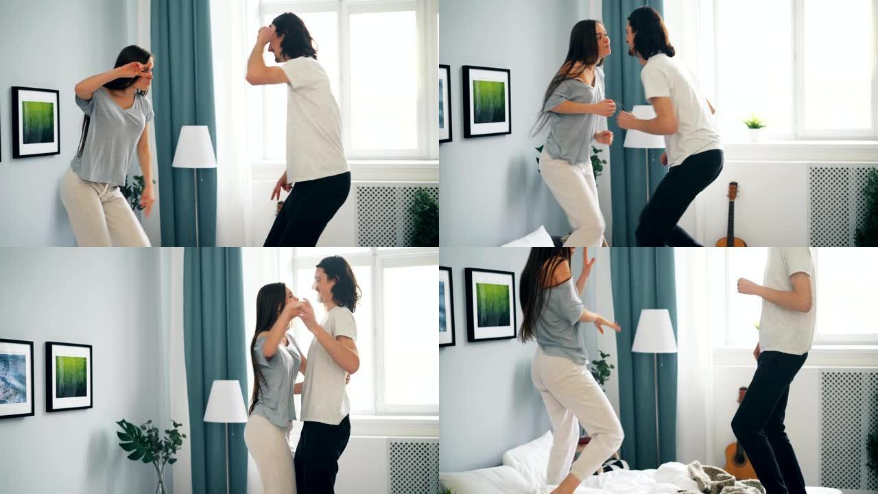 顽皮的学生夫妇在家在卧室的床上跳舞很开心