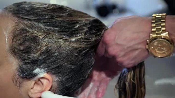 无法识别的发型师洗女顾客的头发