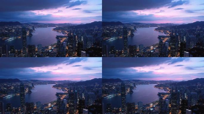 香港中环无人驾驶飞机在夜间的鸟瞰图。大型城市的现代摩天大楼和高楼大厦。