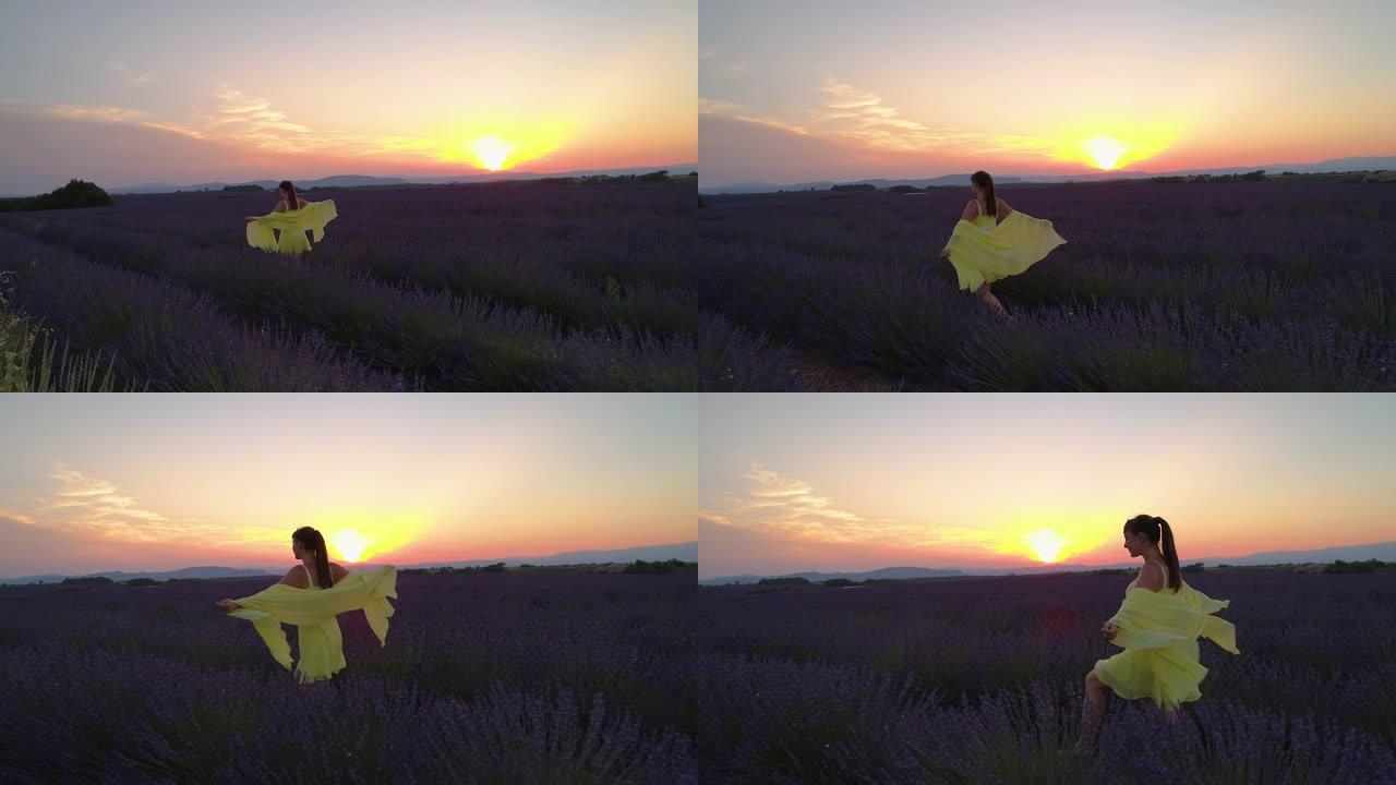 无人机: 日落轻轻地照亮了穿过薰衣草田野的女人。