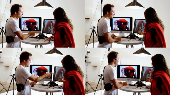 男摄影师在电脑4k上向女模特展示照片