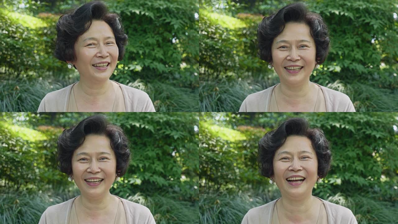微笑的成熟中国女人的户外肖像