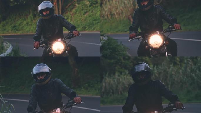 日落时分，骑自行车的人在乡村路上骑经典摩托车