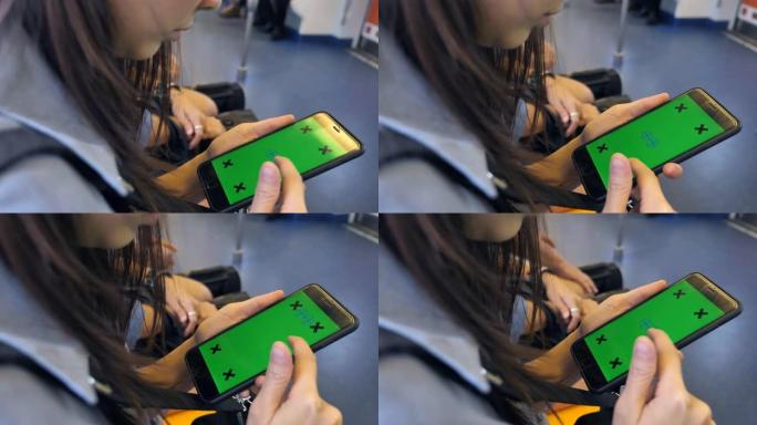 女人在火车上使用智能手机绿屏