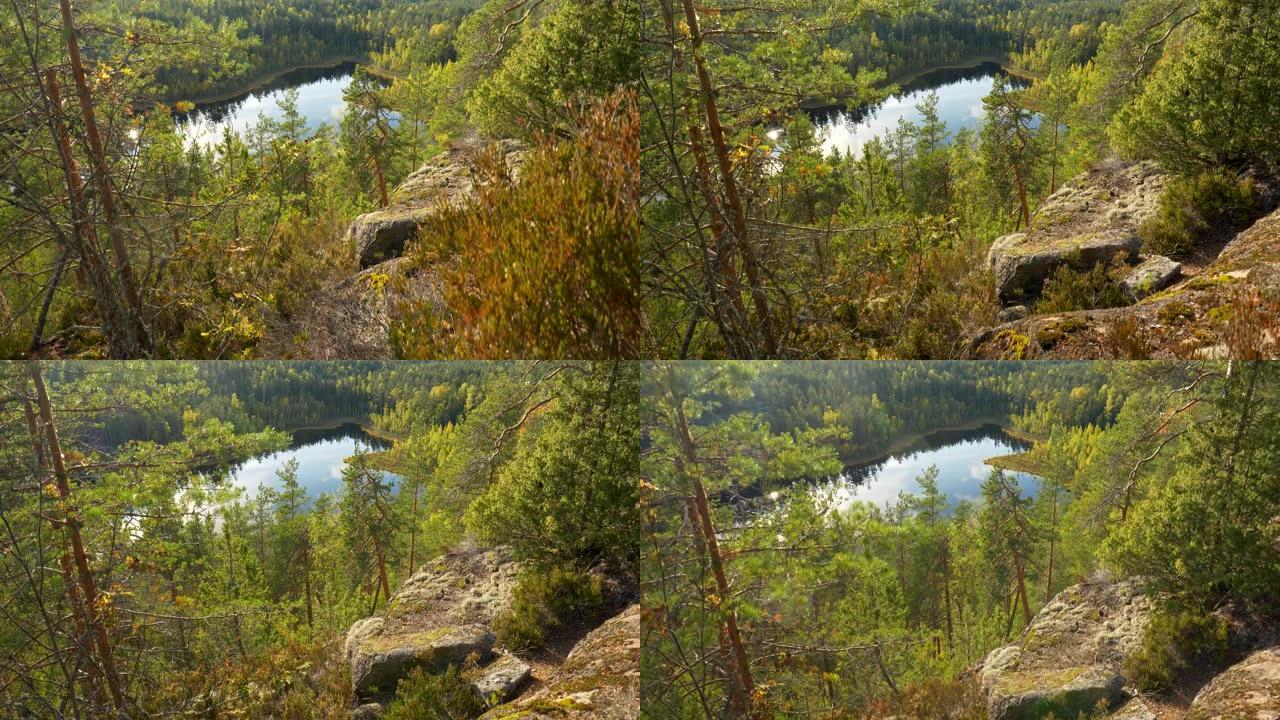 芬兰雷波韦西国家公园的森林、湖泊和岩石的秋季自然景观。4K
