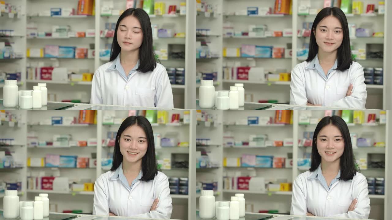 一个年轻的亚洲药剂师女人在药店微笑着看着相机的特写肖像。