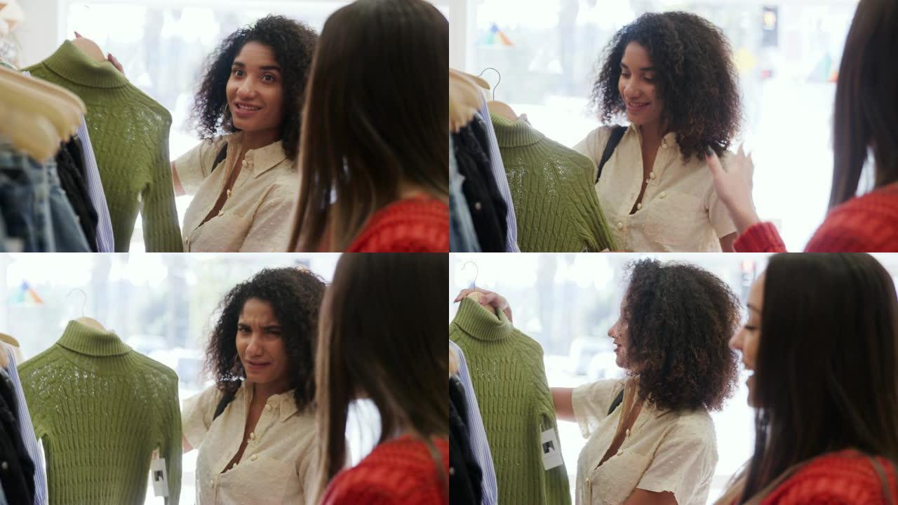 两名年轻女性在时装店的货架上寻找，一起选择套头衫 -- 慢动作拍摄