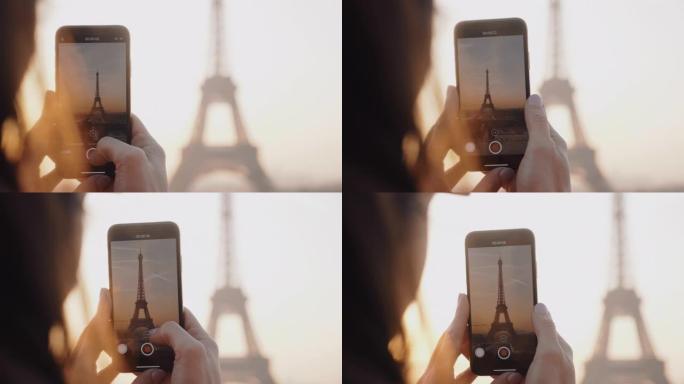 特写快乐当地博客女人用手机慢镜头拍摄史诗般的日落巴黎埃菲尔铁塔天空全景视频。